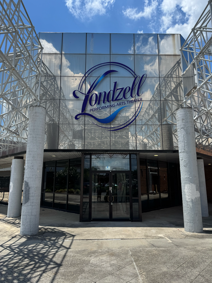Entrance of a building with a large "Laubzel" logo above glass doors.